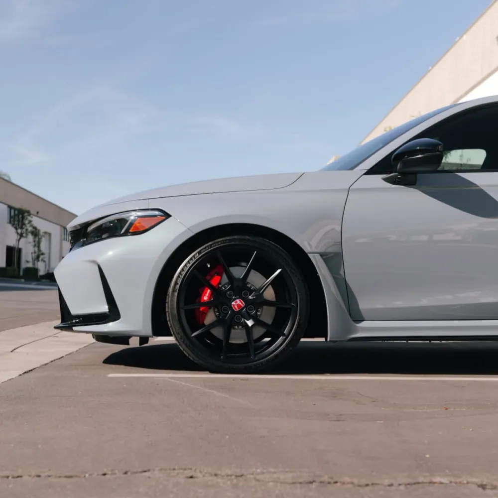 Side profile of a grey Honda Civic Type R front fender with paint protection film.